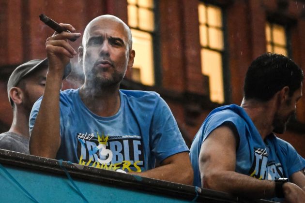 Pep Guardiola enjoys celebrations during Manchester City's open top bus parade