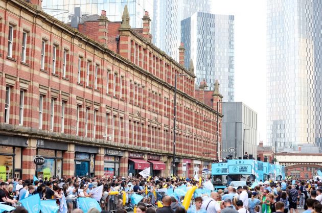 Manchester City fans line the streets of Manchester to welcome home the boys in blue