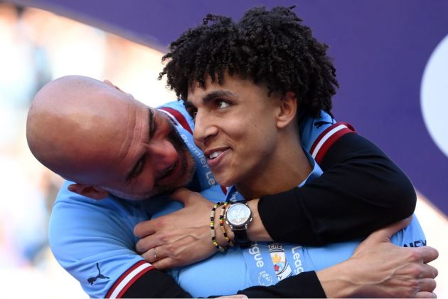 Rico Lewis and Pep Guardiola after winning the Premier League title