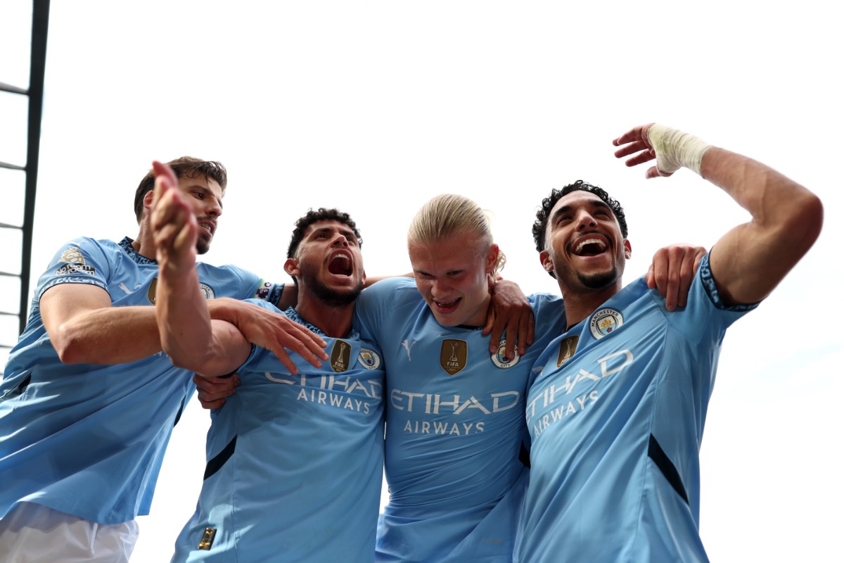 Manchester City players celebrate Erling Haaland's goal at Craven Cottage.